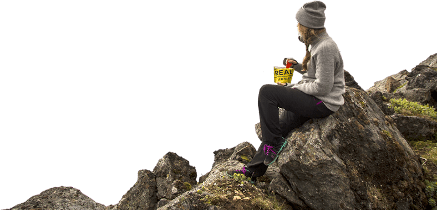 Person eating on a rock