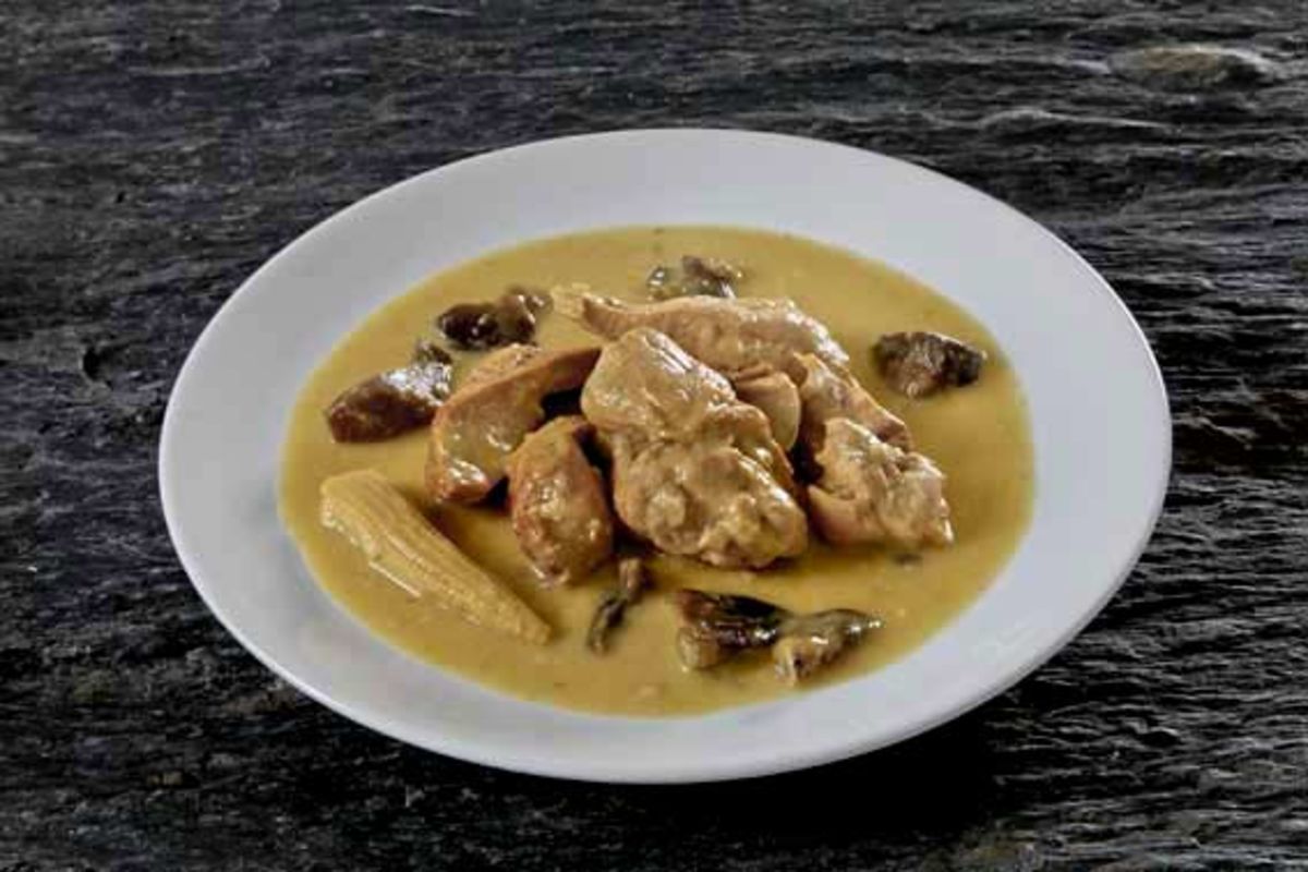 Green curry of chicken fillet with coconut milk
